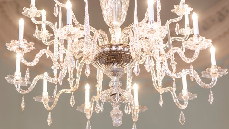 A close-up of one of the chandeliers in Bath Assembly Rooms with the lights on.